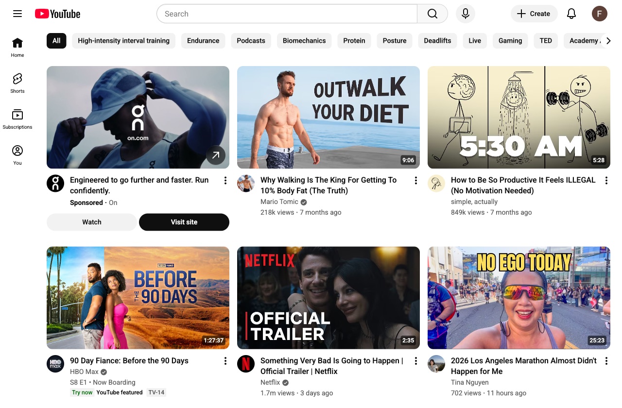 Fitness YouTube homepage on Day 4 showing Zone 2 cardio, high-protein recipes, and strength training videos.
